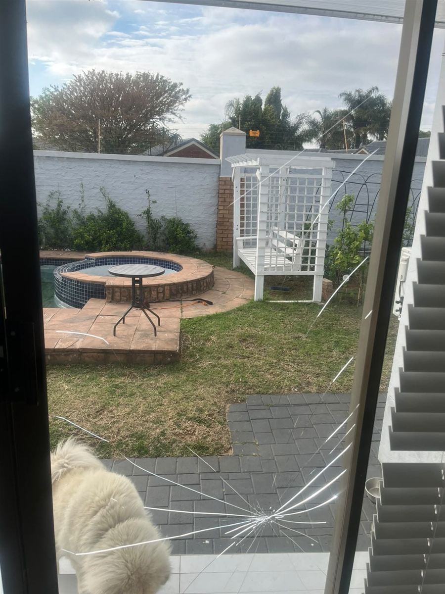 Damaged glazed aluminium patio door panel