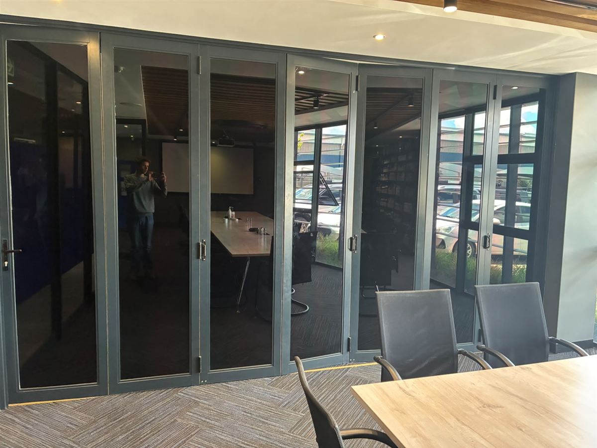 Completed glazed aluminium folding door system at a commercial property